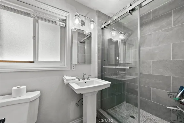 a bathroom with a sink toilet and shower