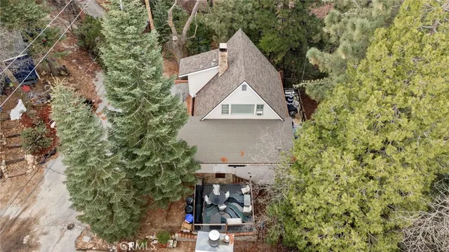 a aerial view of a house with a yard and tree s