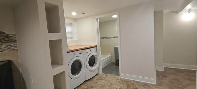 a kitchen with stainless steel appliances granite countertop a sink a stove and a refrigerator