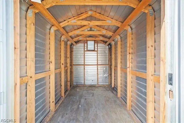 a view of a hallway with wooden floors and door