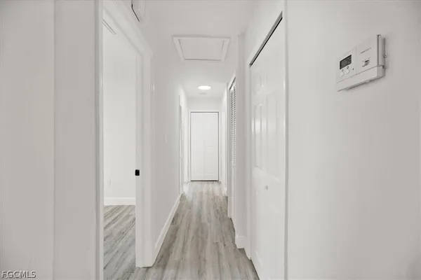 a view of a hallway with wooden floor