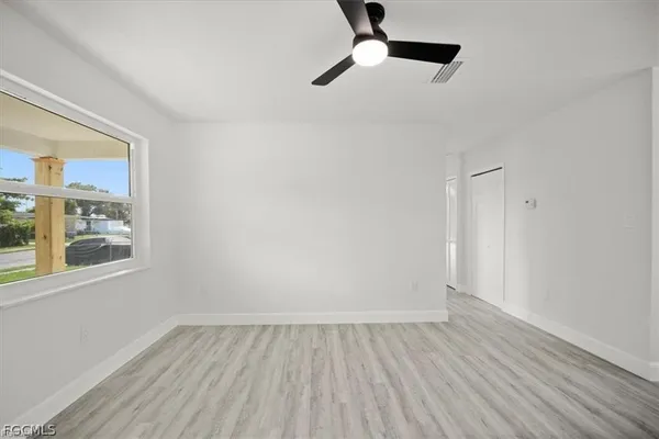 wooden floor in an empty room with a window