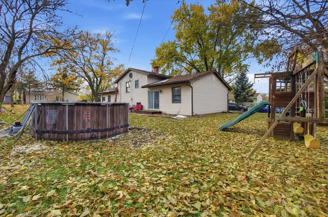 a backyard of a house with table and chairs