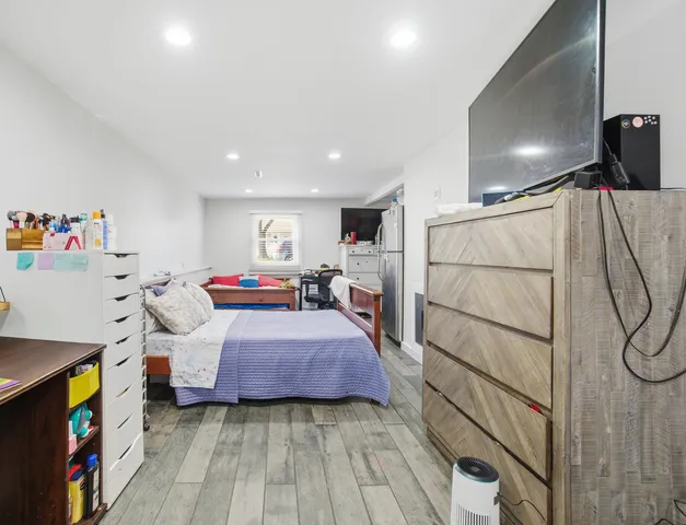 a bed room with a bed and a book shelf