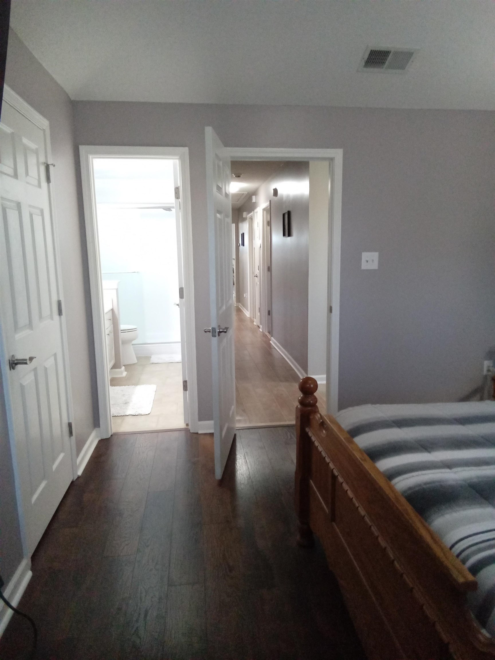 6907 Manslick Road Cordova, TN 38018 - Photo 15 of 24 Bedroom with dark wood-type flooring and ensuite bath