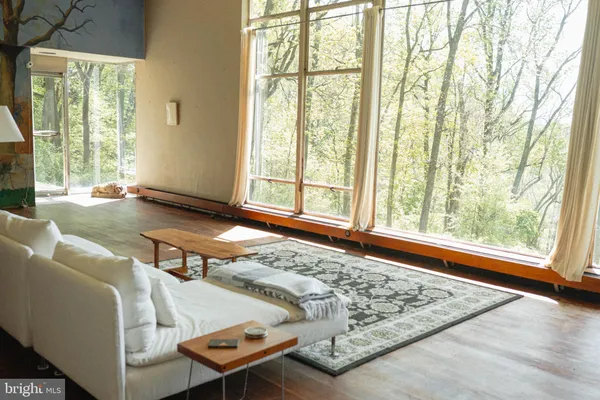 a living room with furniture and a floor to ceiling window