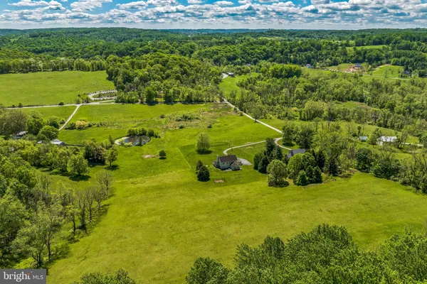a view of grassy field with trees in the background