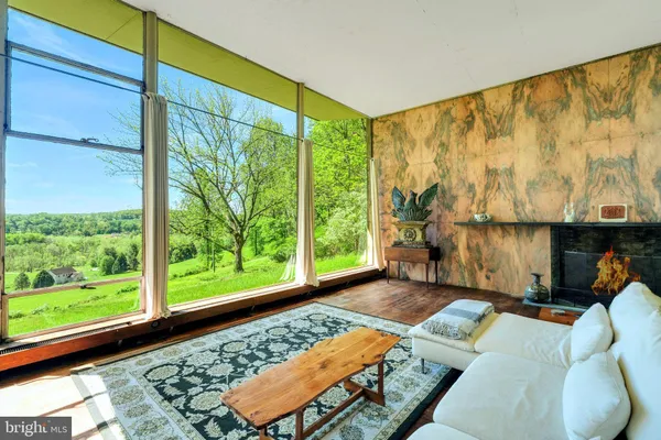 a living room with couch and a large window