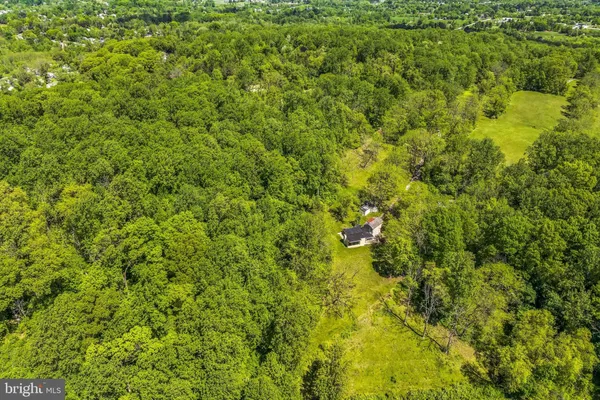 an aerial view of residential house and green space