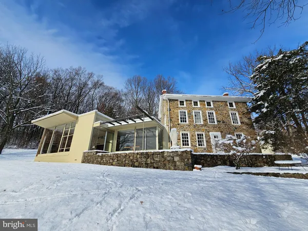 a view of a house with a snow in the yard