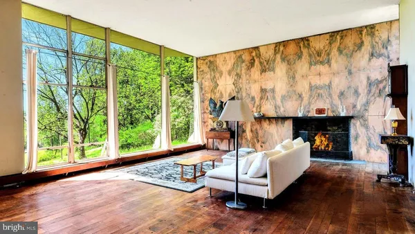 a living room with fireplace furniture and a book shelf