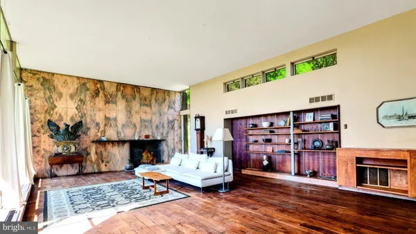 a living room with furniture and a floor to ceiling window