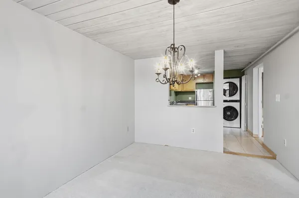 a kitchen with stainless steel appliances granite countertop a sink a stove a washer and dryer