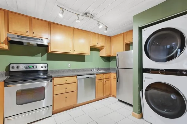 a kitchen with a sink a stove and cabinets