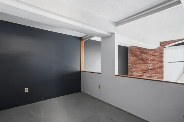 a bathroom with a granite countertop toilet sink and mirror