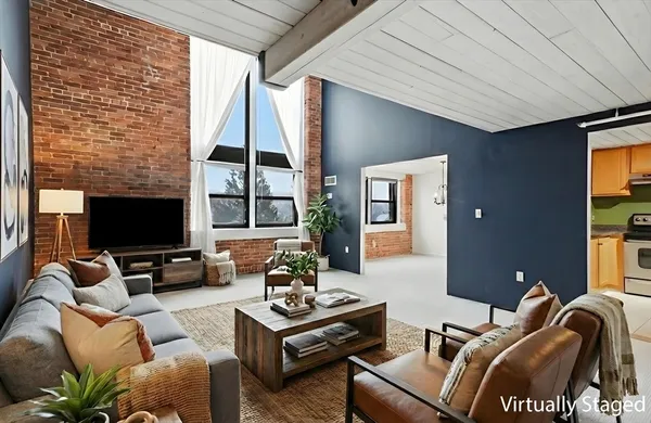 a view of an empty room with cabinet and windows