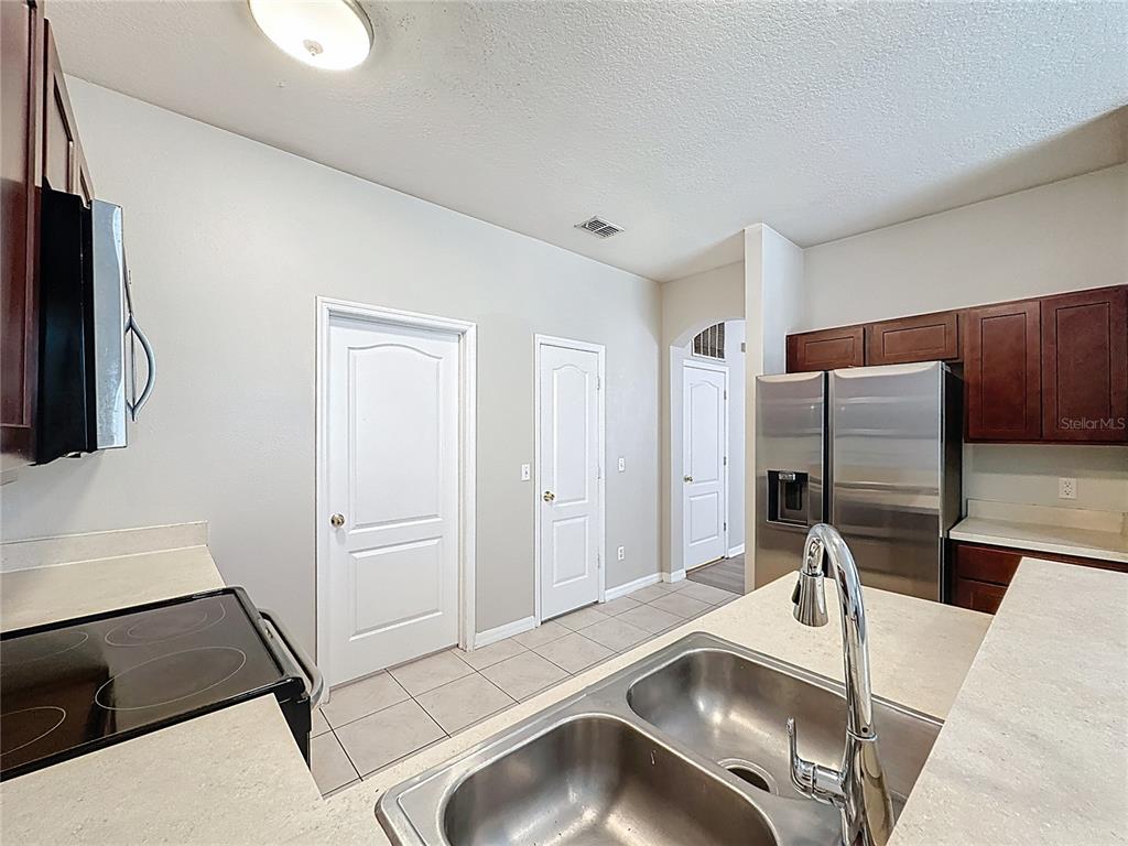1893 Royal Ridge Drive Davenport, FL 33896 - Photo 11 of 38 a kitchen with a refrigerator and a sink
