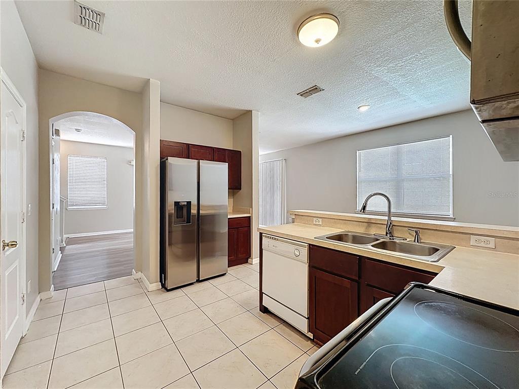 1893 Royal Ridge Drive Davenport, FL 33896 - Photo 12 of 38 a kitchen with a sink and stainless steel appliances