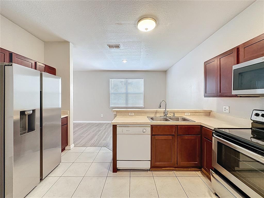 1893 Royal Ridge Drive Davenport, FL 33896 - Photo 13 of 38 a kitchen with a sink and stainless steel appliances