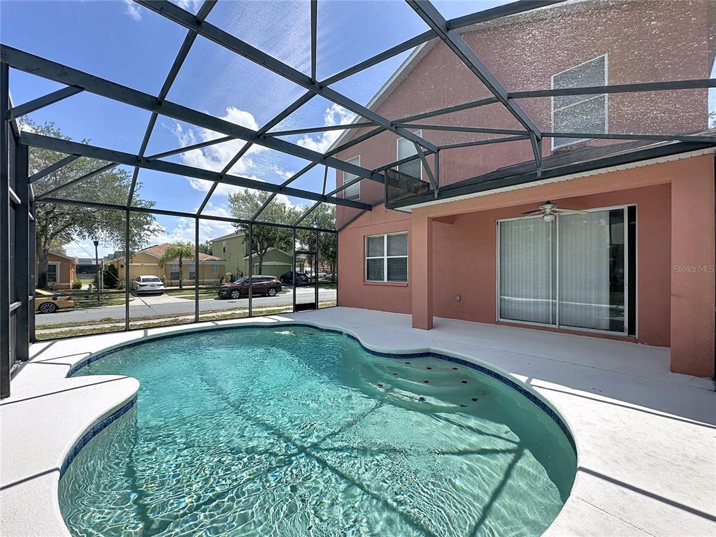1893 Royal Ridge Drive Davenport, FL 33896 - Photo 16 of 38 a view of a backyard with table and chairs under an umbrella