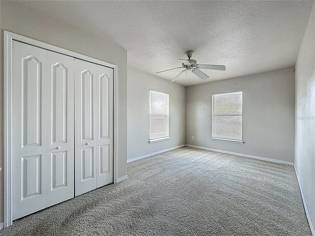 1893 Royal Ridge Drive Davenport, FL 33896 - Photo 23 of 38 an empty room with windows and cabinet