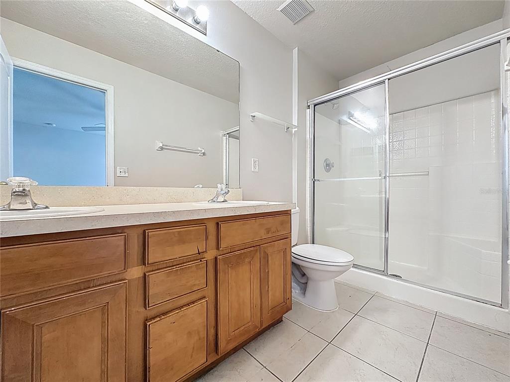 1893 Royal Ridge Drive Davenport, FL 33896 - Photo 31 of 38 a bathroom with a toilet sink and a shower