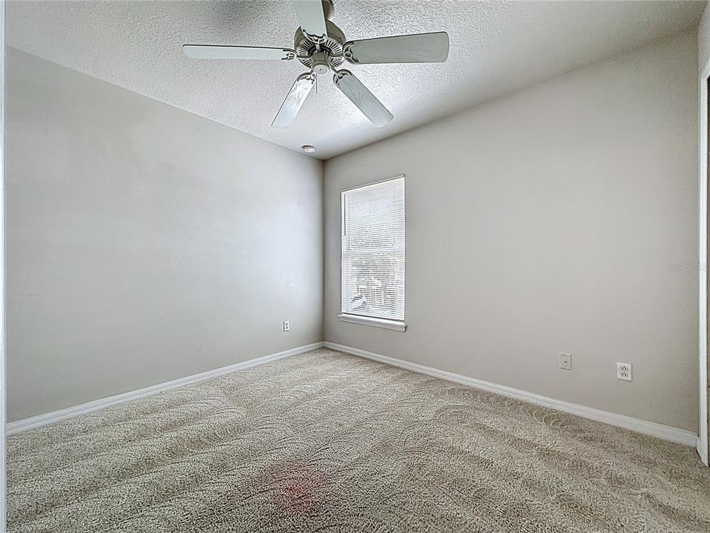 1893 Royal Ridge Drive Davenport, FL 33896 - Photo 32 of 38 an empty room with a window and a fan