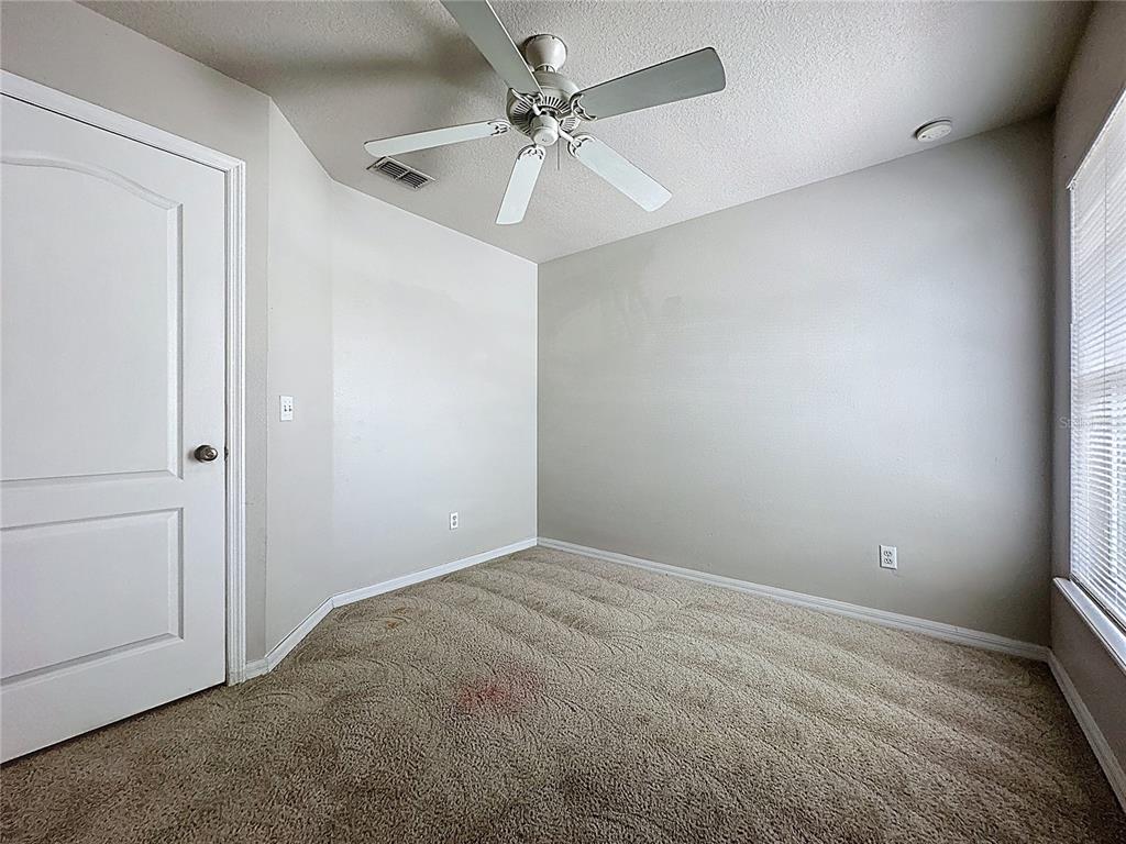 1893 Royal Ridge Drive Davenport, FL 33896 - Photo 33 of 38 an empty room with windows and fan