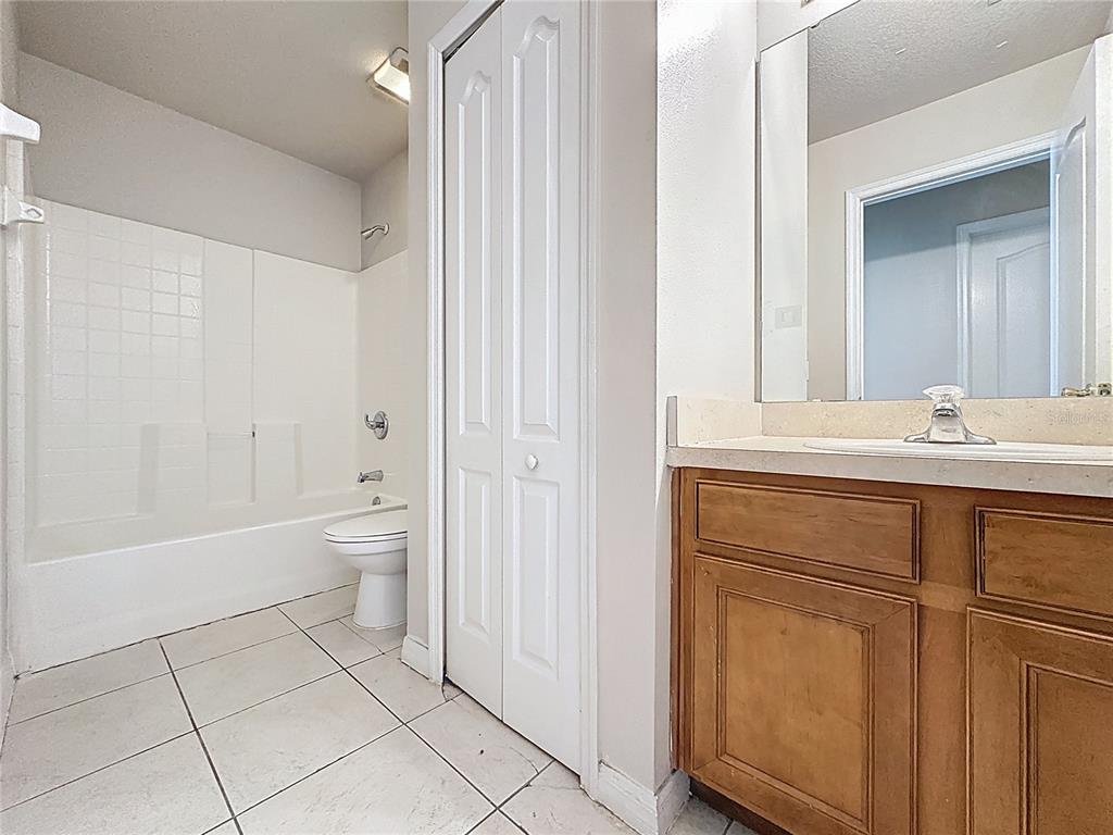 1893 Royal Ridge Drive Davenport, FL 33896 - Photo 35 of 38 a bathroom with a sink a toilet and shower