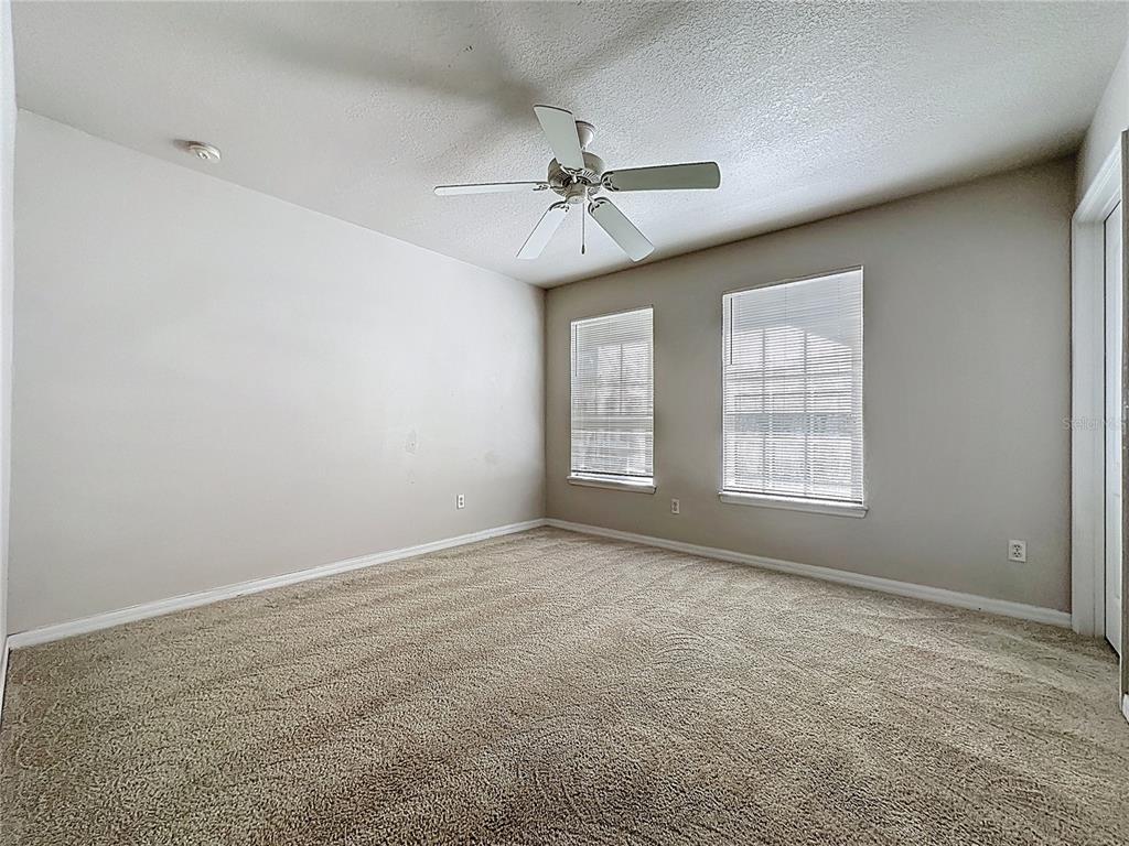 1893 Royal Ridge Drive Davenport, FL 33896 - Photo 36 of 38 an empty room with windows and fan
