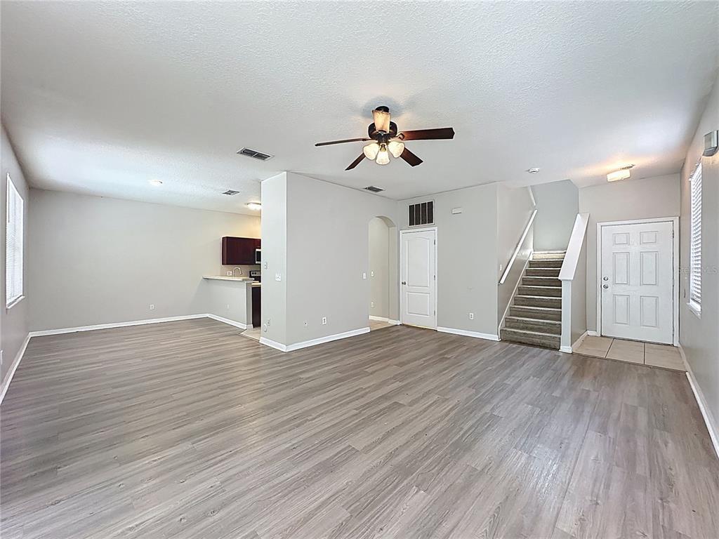 1893 Royal Ridge Drive Davenport, FL 33896 - Photo 5 of 38 a view of empty room with wooden floor and ceiling fan