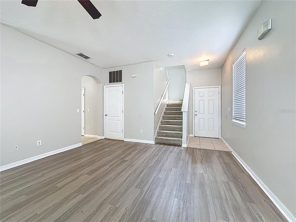 1893 Royal Ridge Drive Davenport, FL 33896 - Photo 6 of 38 wooden floor in an empty room with a window