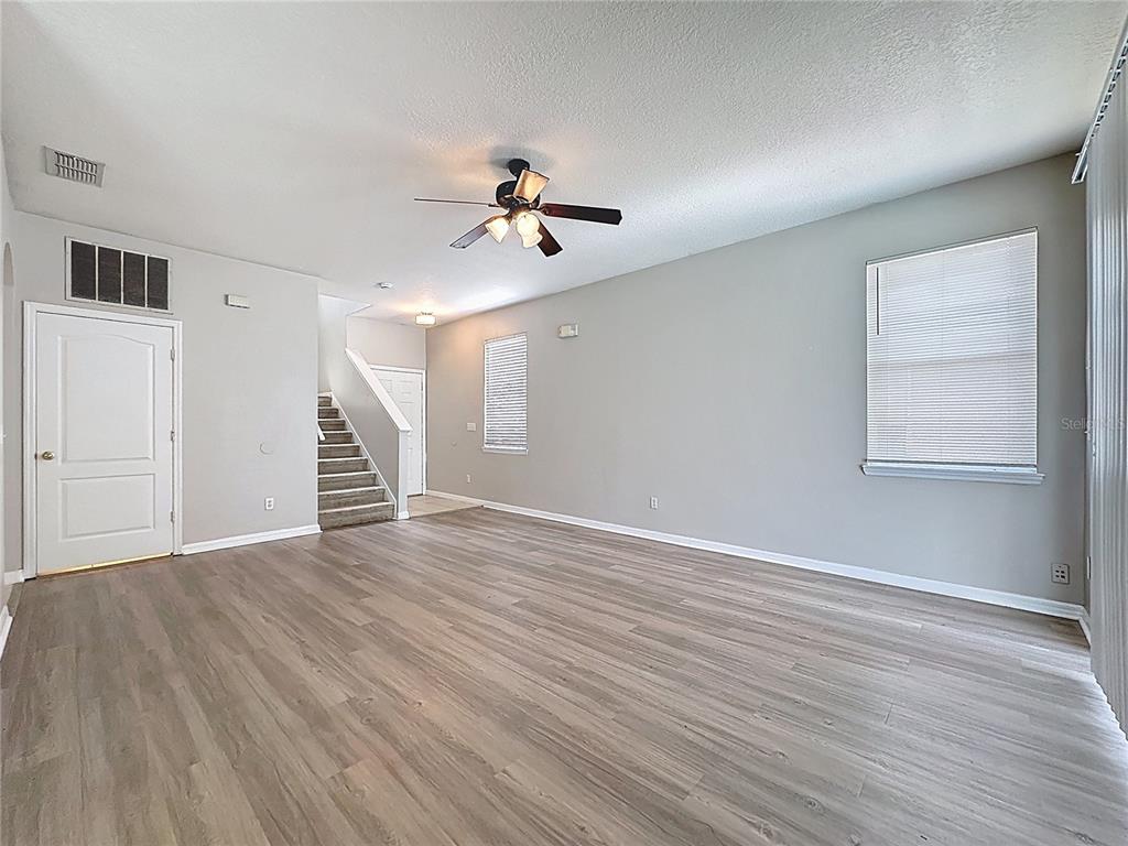 1893 Royal Ridge Drive Davenport, FL 33896 - Photo 7 of 38 a view of an empty room with wooden floor and a window