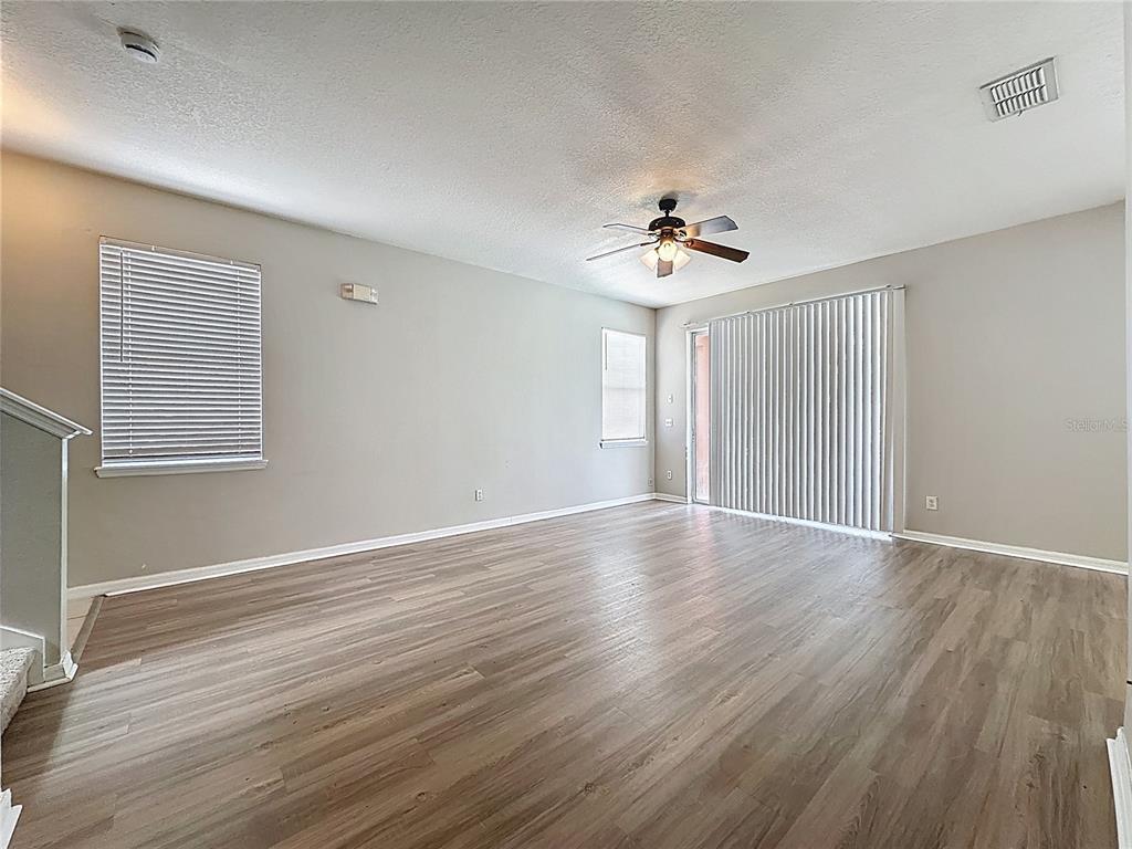 1893 Royal Ridge Drive Davenport, FL 33896 - Photo 8 of 38 wooden floor in an empty room with a window
