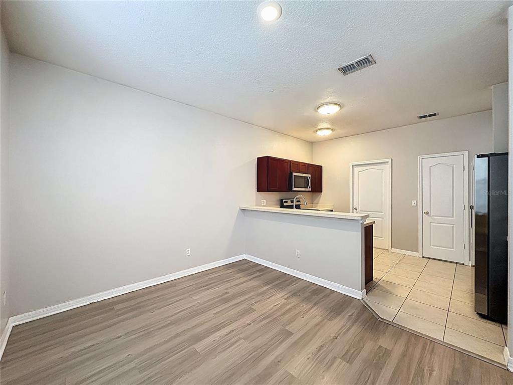1893 Royal Ridge Drive Davenport, FL 33896 - Photo 9 of 38 a view of a room with wooden floor and a flat screen tv