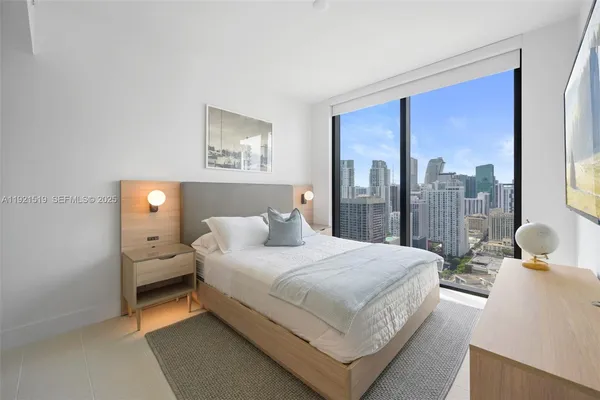 a bedroom with a bed and a lamp