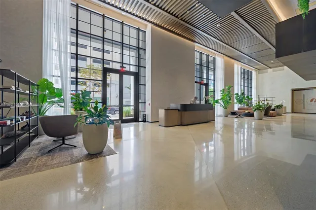 a view of living room filled with furniture and a potted plant