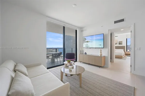 a living room with furniture and a large window