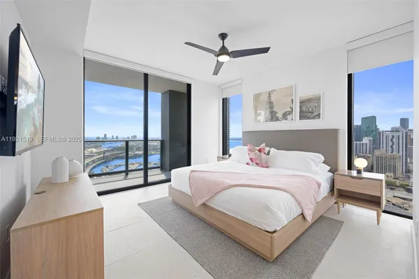 a bedroom with a bed and a chandelier