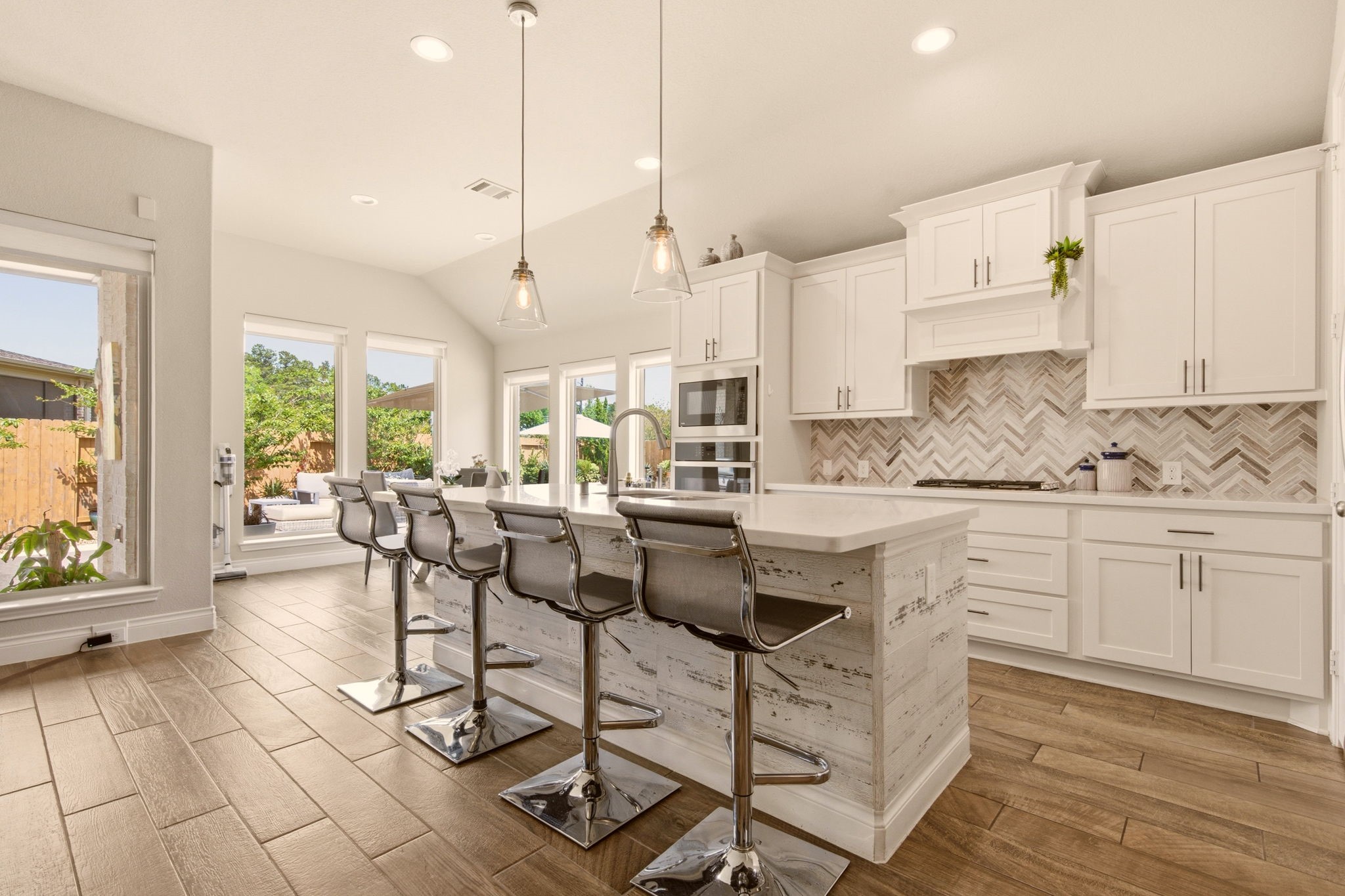 4359 Croft Creek Drive Spring, TX 77386 - Photo 14 of 46 a kitchen with stainless steel appliances granite countertop a stove a sink a dining table and chairs with wooden floor