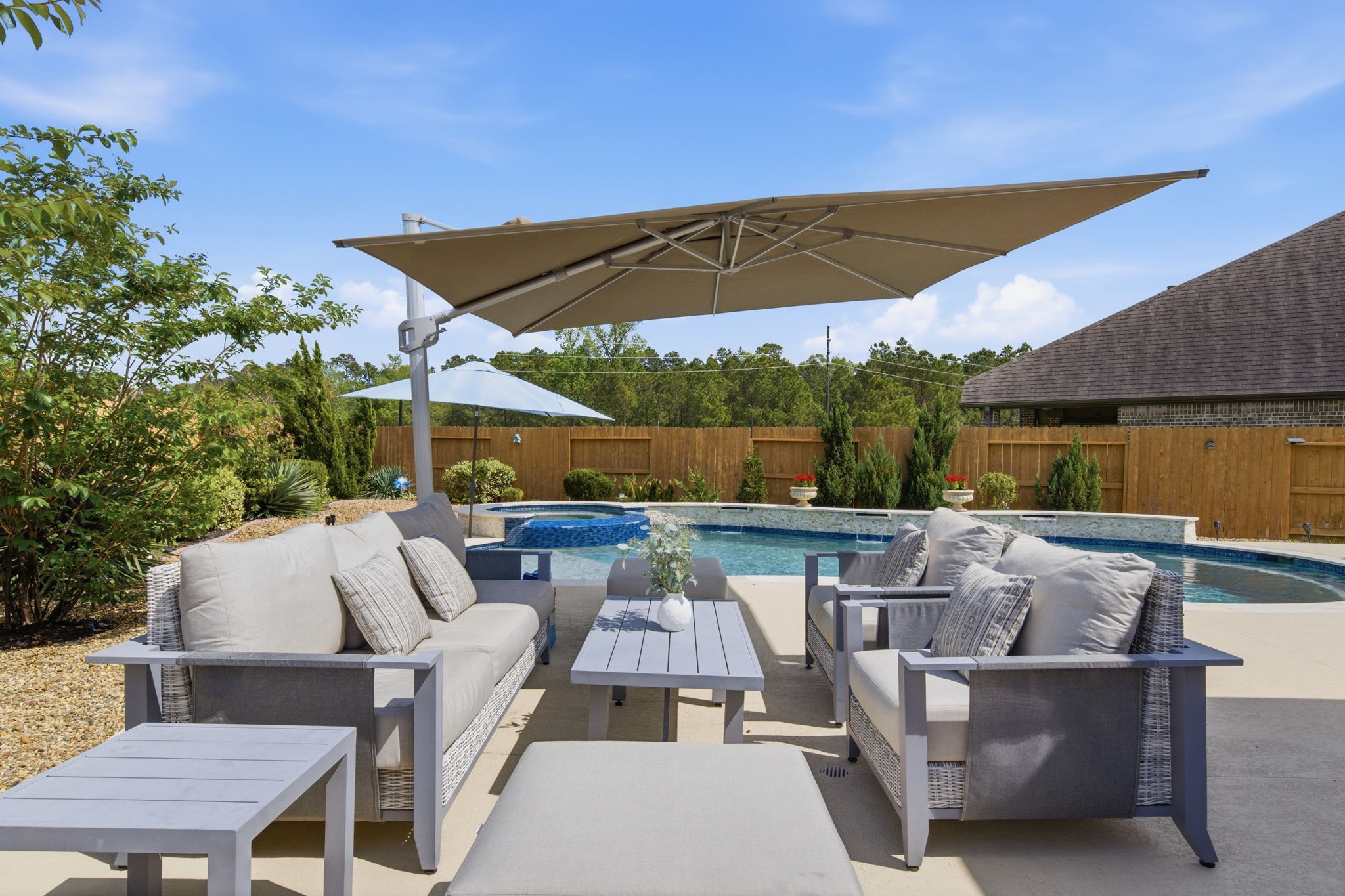 4359 Croft Creek Drive Spring, TX 77386 - Photo 37 of 46 an outdoor sitting area with furniture and umbrella