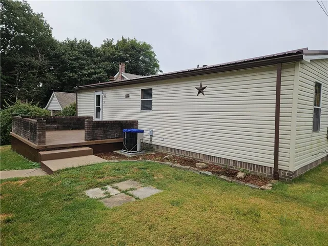 a backyard of a house with table and chairs