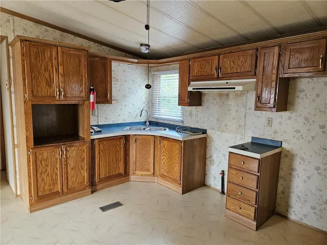 a kitchen with a refrigerator and a stove