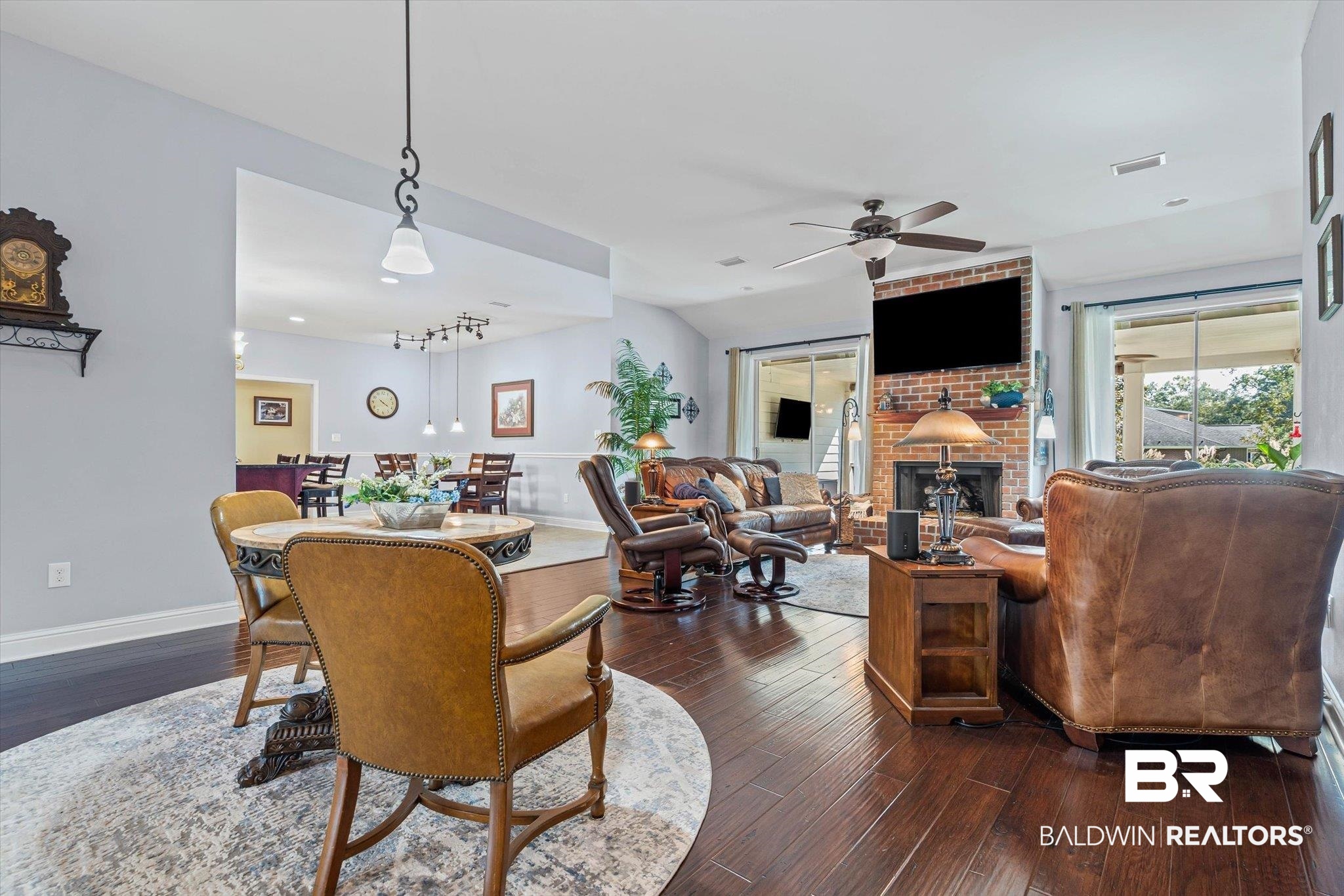 6175 South Grand Bay Wilmer Road Grand Bay, AL 36541 - Photo 4 of 42 Living room featuring dark wood finished floors, a brick fireplace, lofted ceiling, and a ceiling fan
