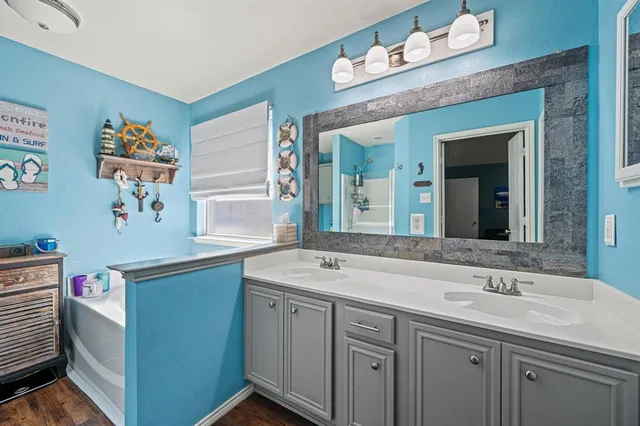 a bathroom with a sink double vanity and a mirror