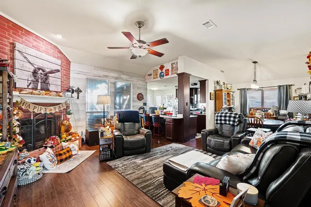 a living room with furniture fireplace and a window
