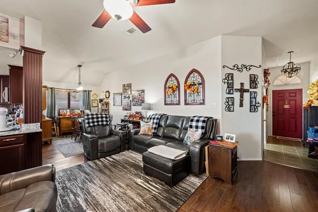 a living room with furniture and wooden floor
