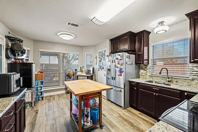 a kitchen that has a lot of cabinets and refrigerator