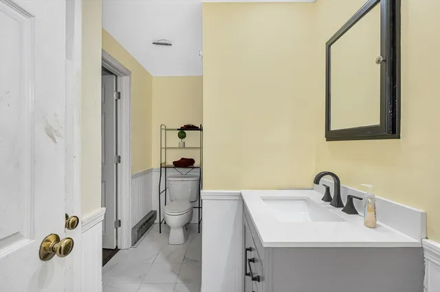 a bathroom with a sink and mirror with shower