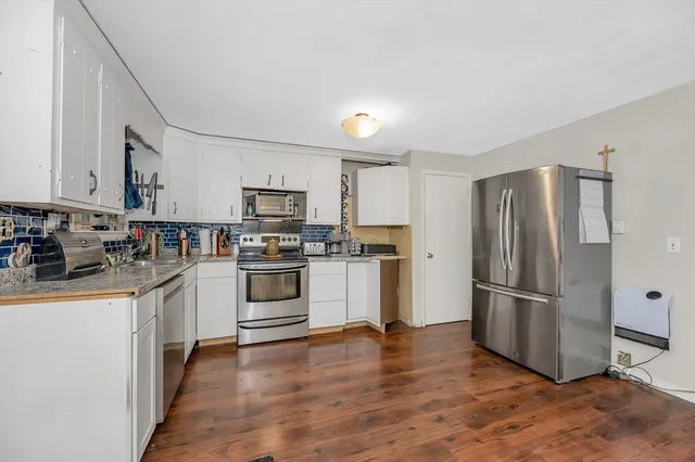 a kitchen with granite countertop stainless steel appliances and wooden cabinets